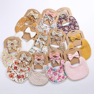 Linen cotton baby bib and headband set featuring assorted prints and ruffled pom edges