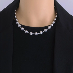 Polished silver stainless steel ball chain necklace worn on a black blazer outfit