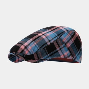 Close-up of navy and pink plaid flat cap showing premium twill fabric and stitching