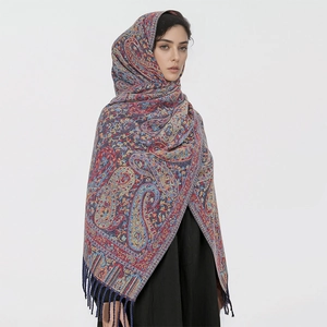 Detail of premium paisley pattern scarf with elegant fringe tassels on high-quality fabric