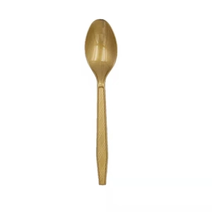 Detailed macro view of a golden plastic spoon with diamond pattern handle on white background