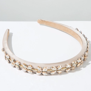 Detailed view of champagne satin headband with marquise crystals and golden rhinestone chain