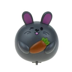 Close-up of a grey toy rabbit pulling a carrot on a pull-back car base for Easter gift