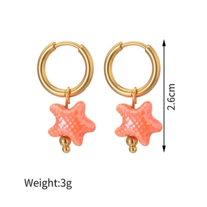 Detail of 18K gold stainless steel hoop earrings with orange-pink starfish pendants