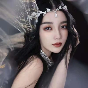 Exquisite silver bridal headpiece and necklace set worn by a model for elegant wedding styling
