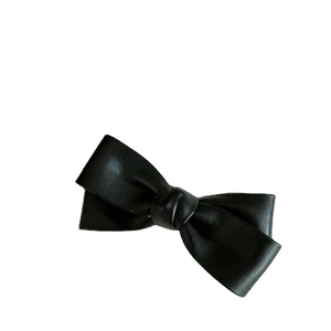 Elegant black PU leather bow hair clip with textured finish on a clean white background