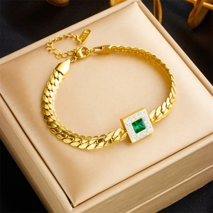 Vintage gold-plated titanium bracelet with square emerald and zircon halo on jewelry box
