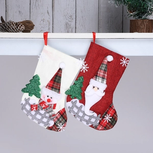 Linen Christmas stockings with Santa and Snowman patterns on a white wooden hanger
