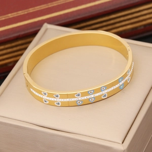 Detail view of gold heart bracelet with blue enamel and sparkling cubic zirconia stones
