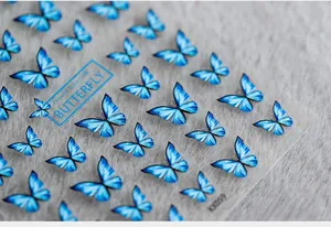 Close-up detail of blue 5D butterfly nail stickers with delicate gradient and fine outlines