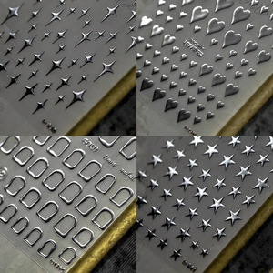 Silver laser nail art stickers featuring stars and heart patterns for DIY manicure