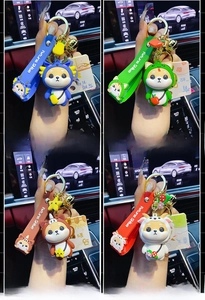 Detail of four zodiac Shiba Inu keychains with dragon snake horse and goat motifs