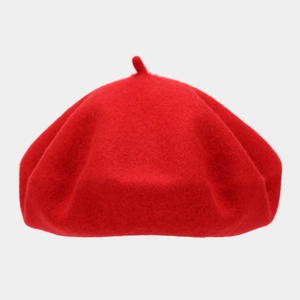 Detailed texture of thick red wool beret showing classic top stem and vintage finish