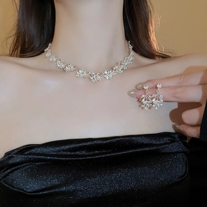 Sparkling silver leaf floral jewelry set featuring a diamond necklace and drop earrings