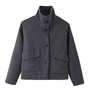 Detailed view of the dark grey wool jacket featuring a mock neck and single-breasted buttons