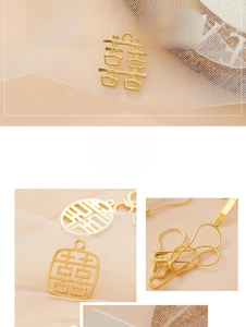Macro detail of golden Double Happiness wedding charms with pins for gift box decoration