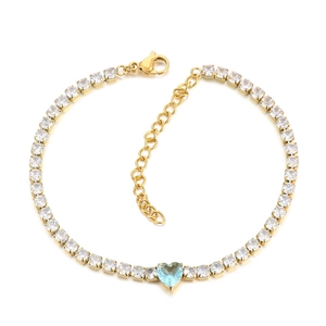Elegant gold tennis bracelet featuring sparkling crystals and a light blue heart-shaped gem