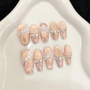 Handmade cat eye press-on nails with 3D white bow and rhinestone butterfly designs