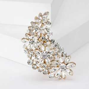 Close-up of a vintage golden floral brooch with sparkling clear crystal rhinestones
