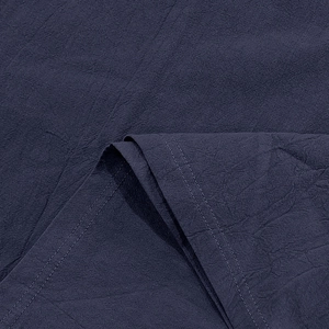 Close-up of navy blue linen fabric texture with premium double-stitch sewing details