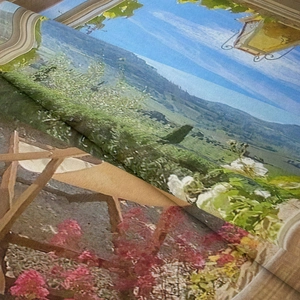 Close-up of bohemian wall tapestry showing fine canvas texture and rural landscape print
