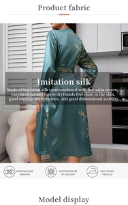 Detail of dark green imitation silk robe showing golden floral pattern and waist tie