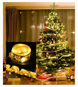 Detail of warm gold LED ribbon lights with festive prints for Christmas tree decoration