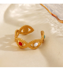 Close-up of gold-plated evil eye ring featuring vibrant red, white and teal enamel inlay