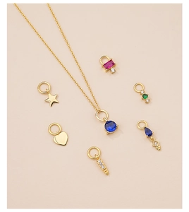 Macro view of gold S925 silver necklace with colorful heart and star zircon pendants