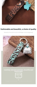 Detail of embossed leather keychain with turquoise accent and blessed silver tag
