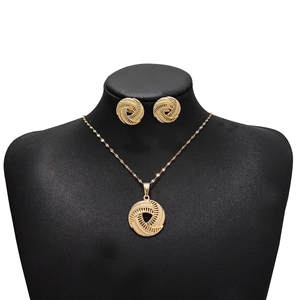 Detailed view of vintage gold hollow circle necklace and earrings set on a black display