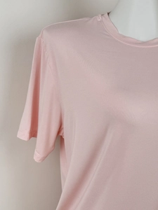 Close-up of pink round neck T-shirt showing detailed soft knitted fabric texture
