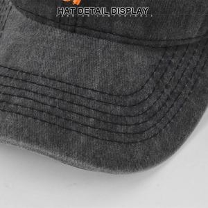 Close-up of a washed black baseball cap brim with durable six-row stitching detail