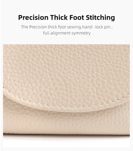 Close-up of precise heavy stitching on high-quality lychee grain leather wallet