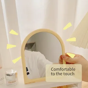 Minimalist irregular wave-shaped vanity mirror with arch frame for desktop makeup use