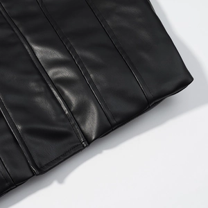 Macro detail of high-quality black faux leather texture and precise stitching on the jacket