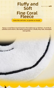 Close-up of white coral fleece towel showing soft high-density fabric texture and black edges