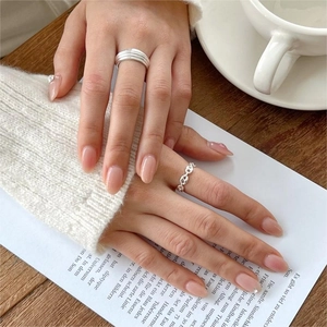 Detail of 925 sterling silver multi-layer ring and chain hollow band on hand