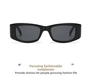 Detailed close-up of glossy black rectangular sunglasses with thick frames and grey lenses