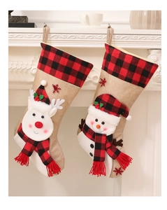 Close-up of 3D reindeer and snowman burlap Christmas stockings hanging on a white fireplace