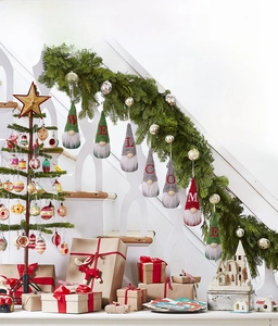 Detailed view of 7 Christmas gnomes with WELCOME letters hanging on stair handrails