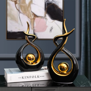 Modern black and gold ceramic abstract sculptures on marble table for luxury home decor