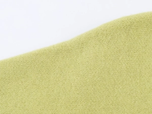 Close-up of lime green knitted fabric showing detailed soft texture and fine knit weave