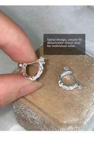 Detail of silver U-shaped zircon earrings with detachable screw back closure