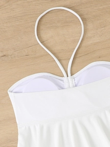 Detail of white halter swimwear with ribbed texture and built-in soft padded cups