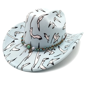 Light blue western cowboy hat with bird print, bead band and turquoise leaf pendant detail