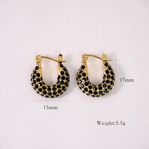 Detailed view of gold C-shaped hoop earrings with green cubic zirconia and size dimensions