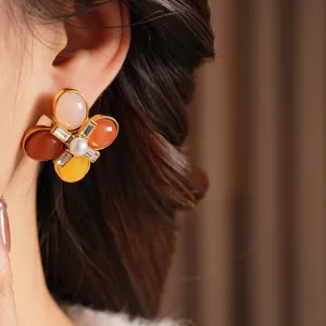 Vintage gold floral stud earrings with multi-color petals and center pearl detail