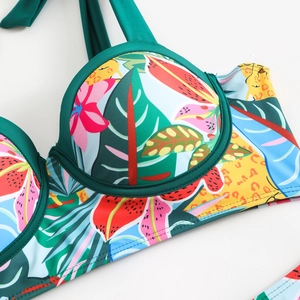 Macro detail of tropical floral and leopard print bikini top with underwire support