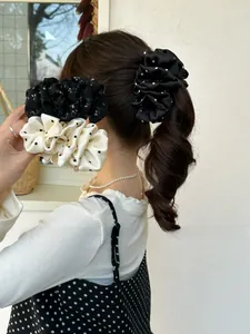Detailed view of satin polka dot and floral scrunchies set for ponytail styling